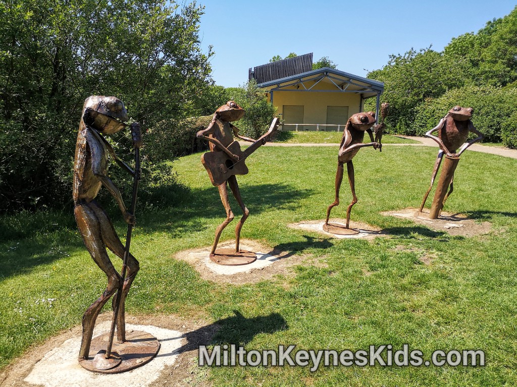 Frog band sculptures at Howe Park Wood in Milton Keynes