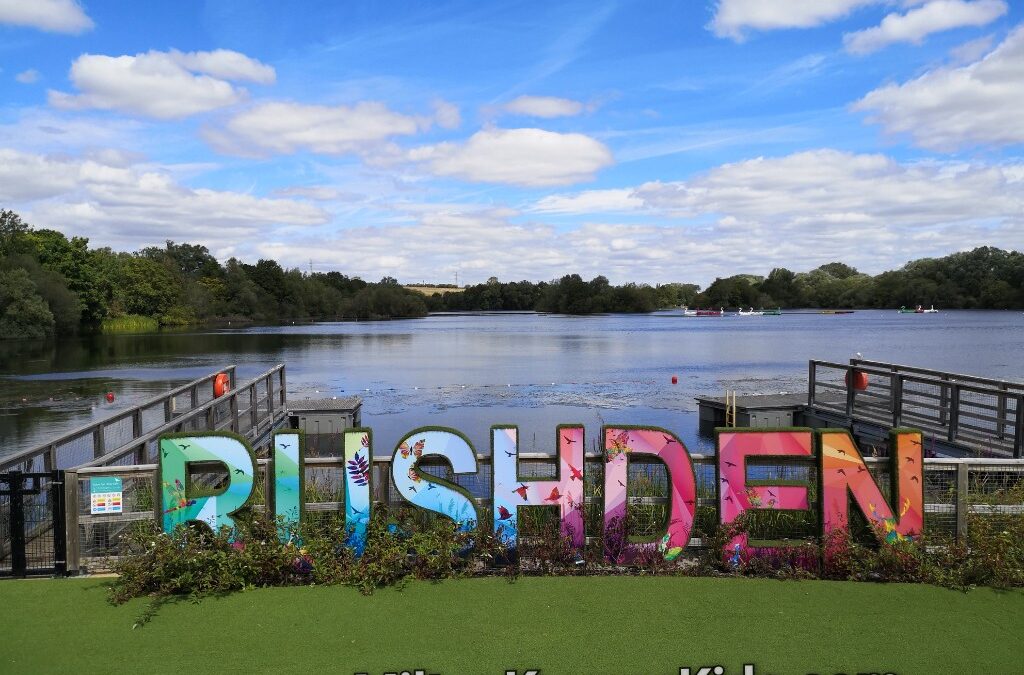Rushden Lakes sign in front of the lake