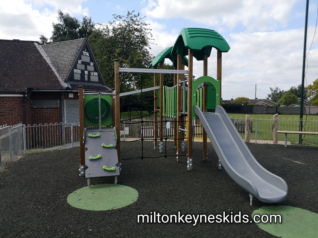 Small green climbing frame with silver slide. 
